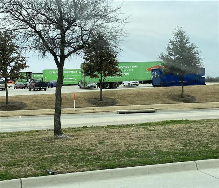 Parking lot in Dallas, TX full of SERVPRO green trailers. Storm Team had arrived.
