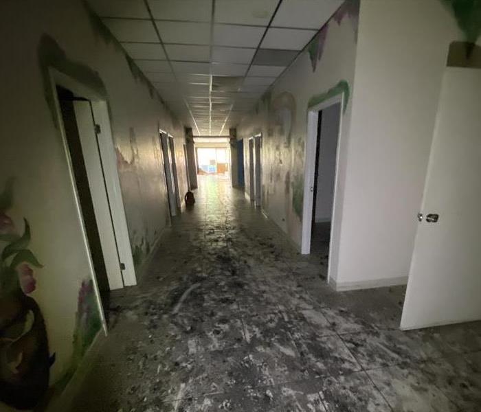 Hallway in vacant commercial building with smoke and soot damage 