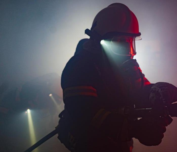 A firefighter in a smokey room
