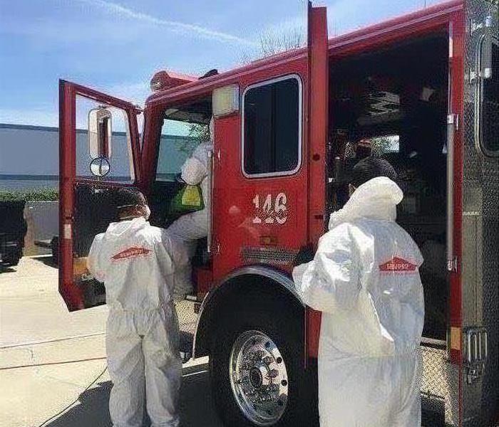 SERVPRO techs in full PPE's sanitizing our local fire truck